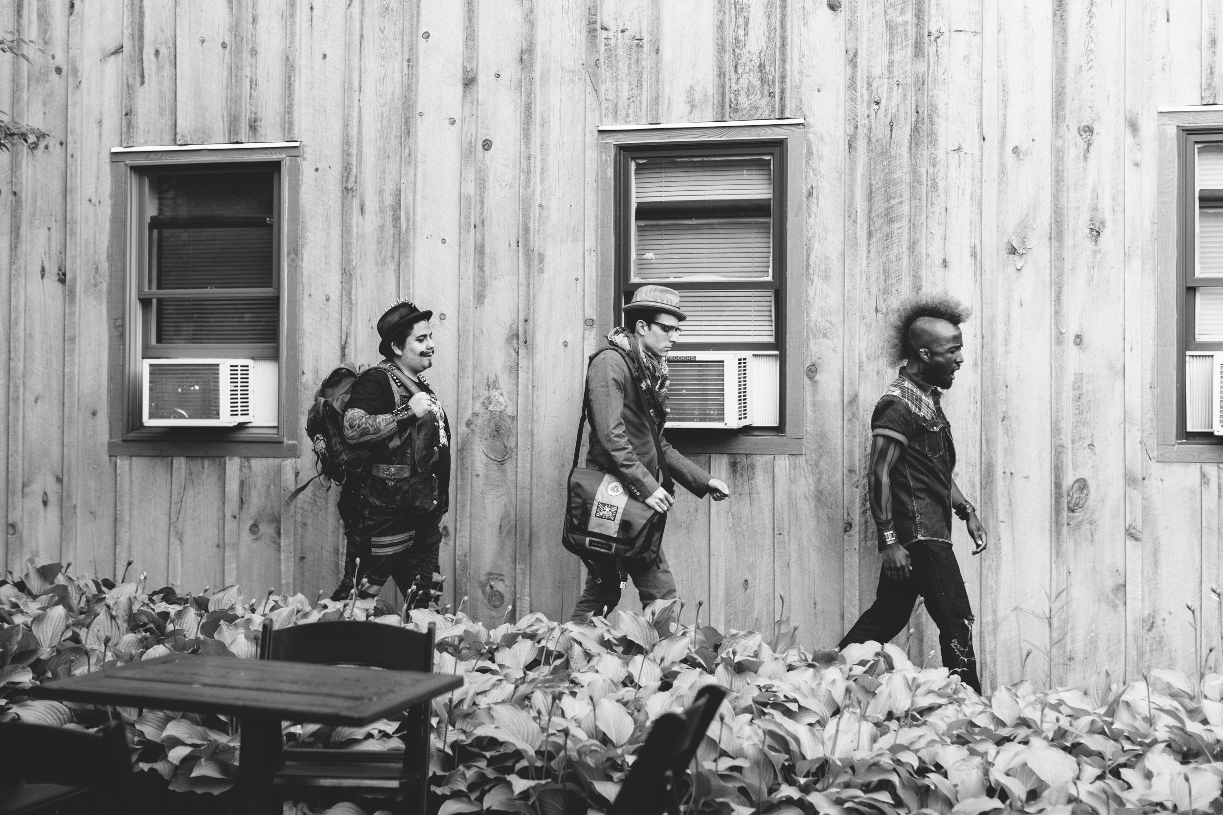 Three men walking in costume.